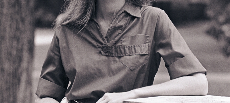 black and white photo of woman outside with pedestal