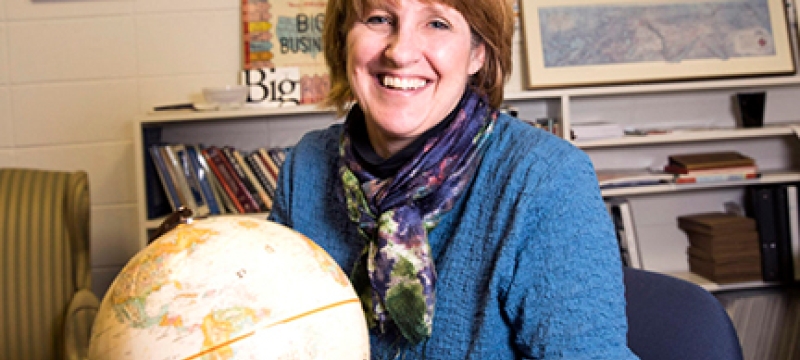 photo of woman with globe