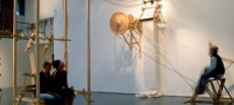 people with wooden sculpture