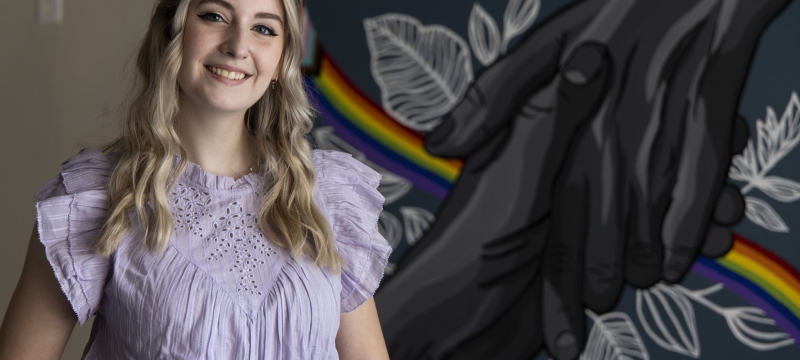 photo of woman with mural