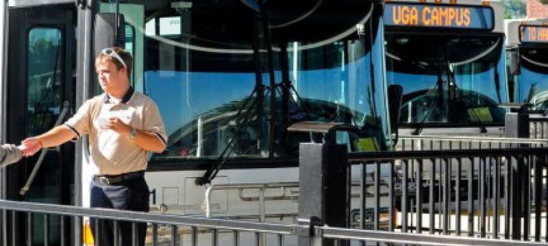 man in front of buses