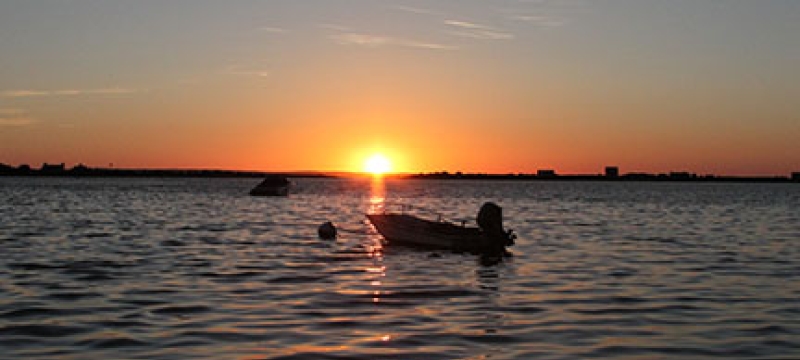 sunset with boat and water
