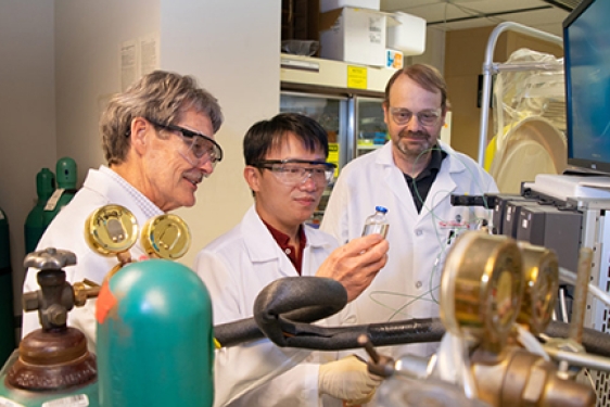 photo of three men in a lab