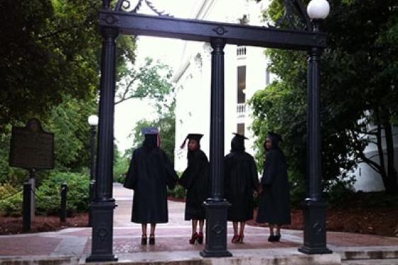 caps and gowns at the arch