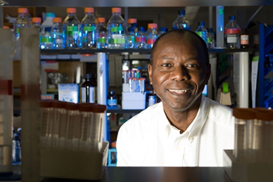 man in lab with beakers, bottles