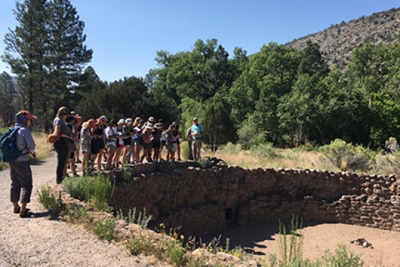 students standing near ancient burial site