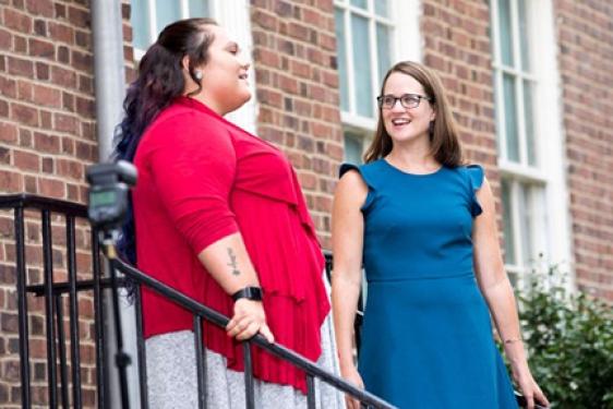 two women on stairs outside of Old College