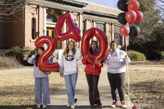 photo of students holding inflatable numbers, balloons, day