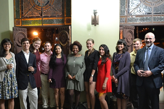 group photo in front of old large doors