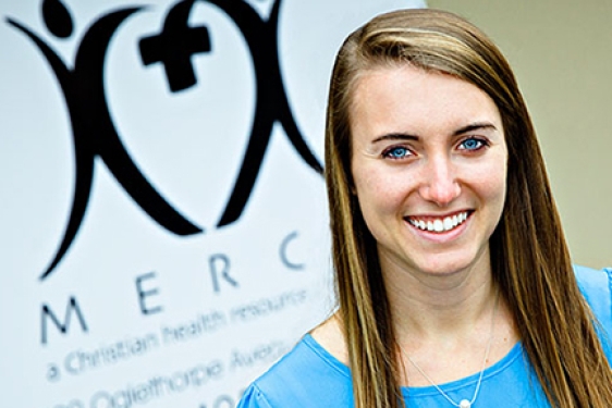 woman in front of hospital sign