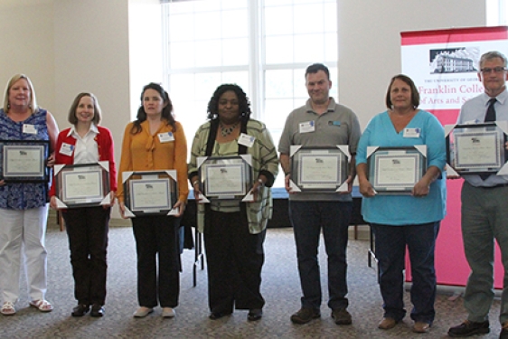 7 people with award plaques