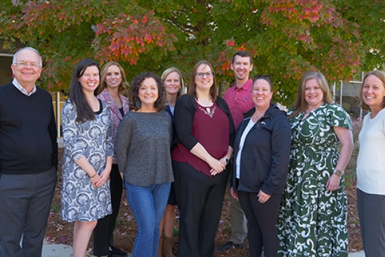 group photo of people, trees in background